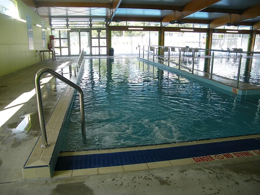 A clean indoor swimming pool with lane markings