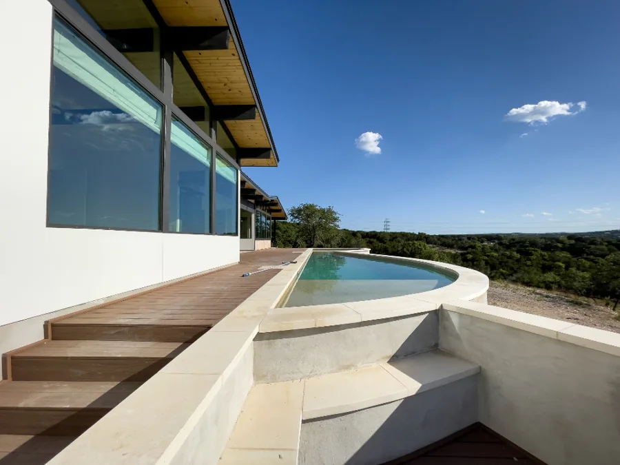 An infinity pool beside a modern building